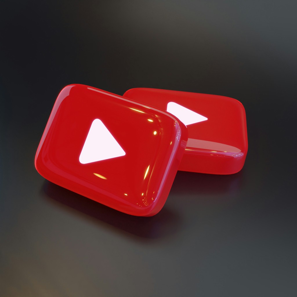 3D YouTube play button icons on a dark surface