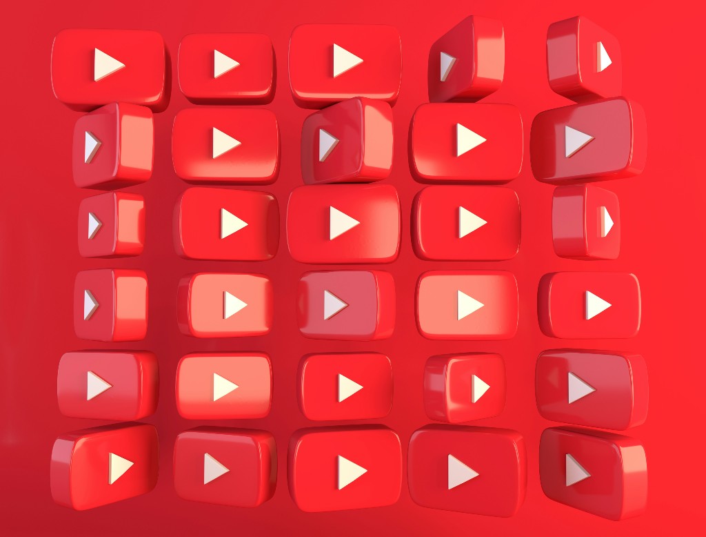 3D YouTube play button icons on a red background