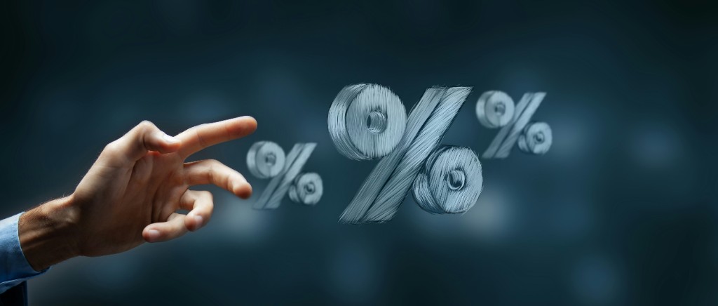 Hand pointing at percentage symbols representing clear pricing and value